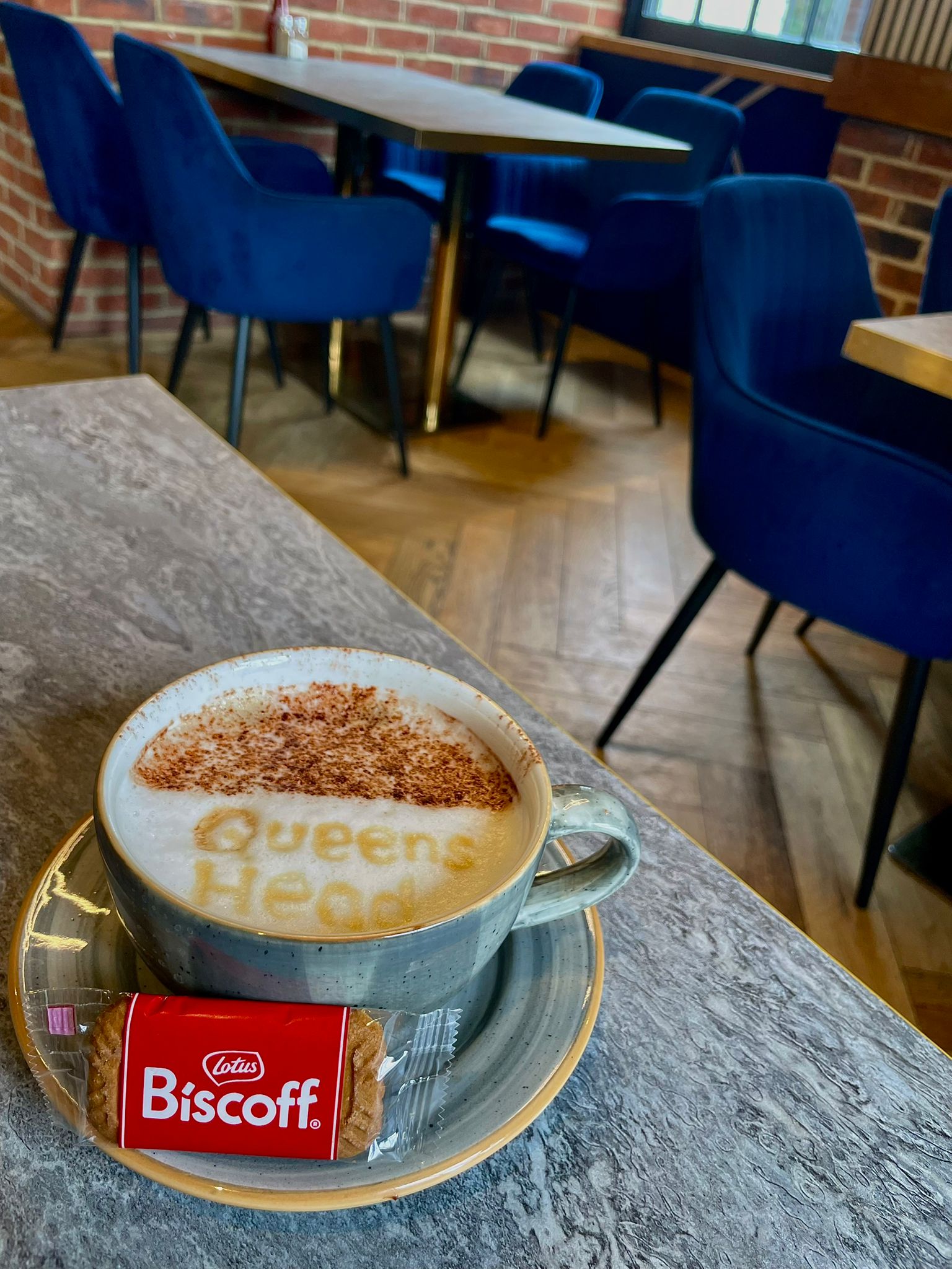 Signature Queen's Head Kingsnorth latte with biscoff biscuit