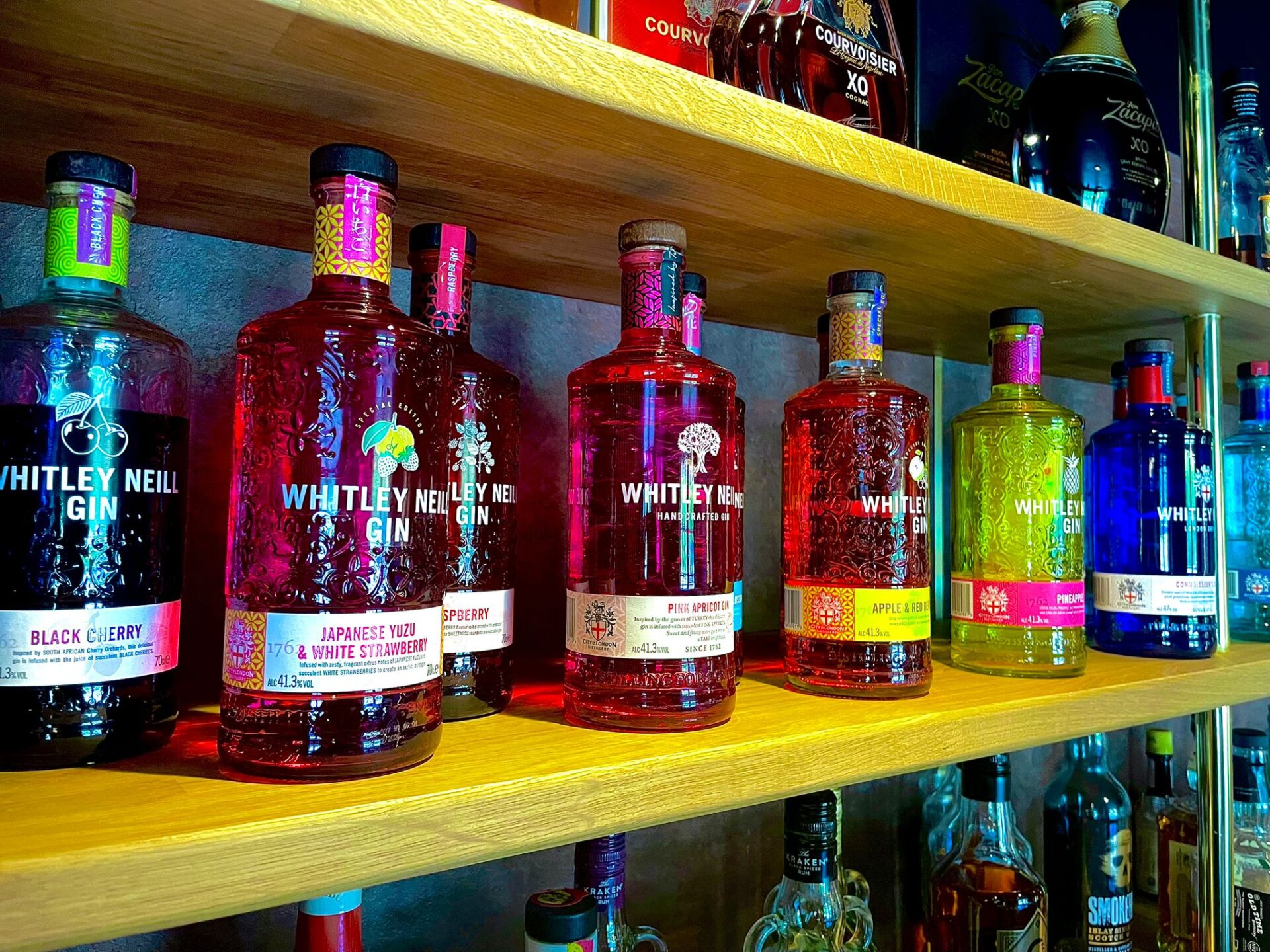 Bottles of Whitley Neill Gin in different flavours at The Queen's Head Kingsnorth pub behind the bar