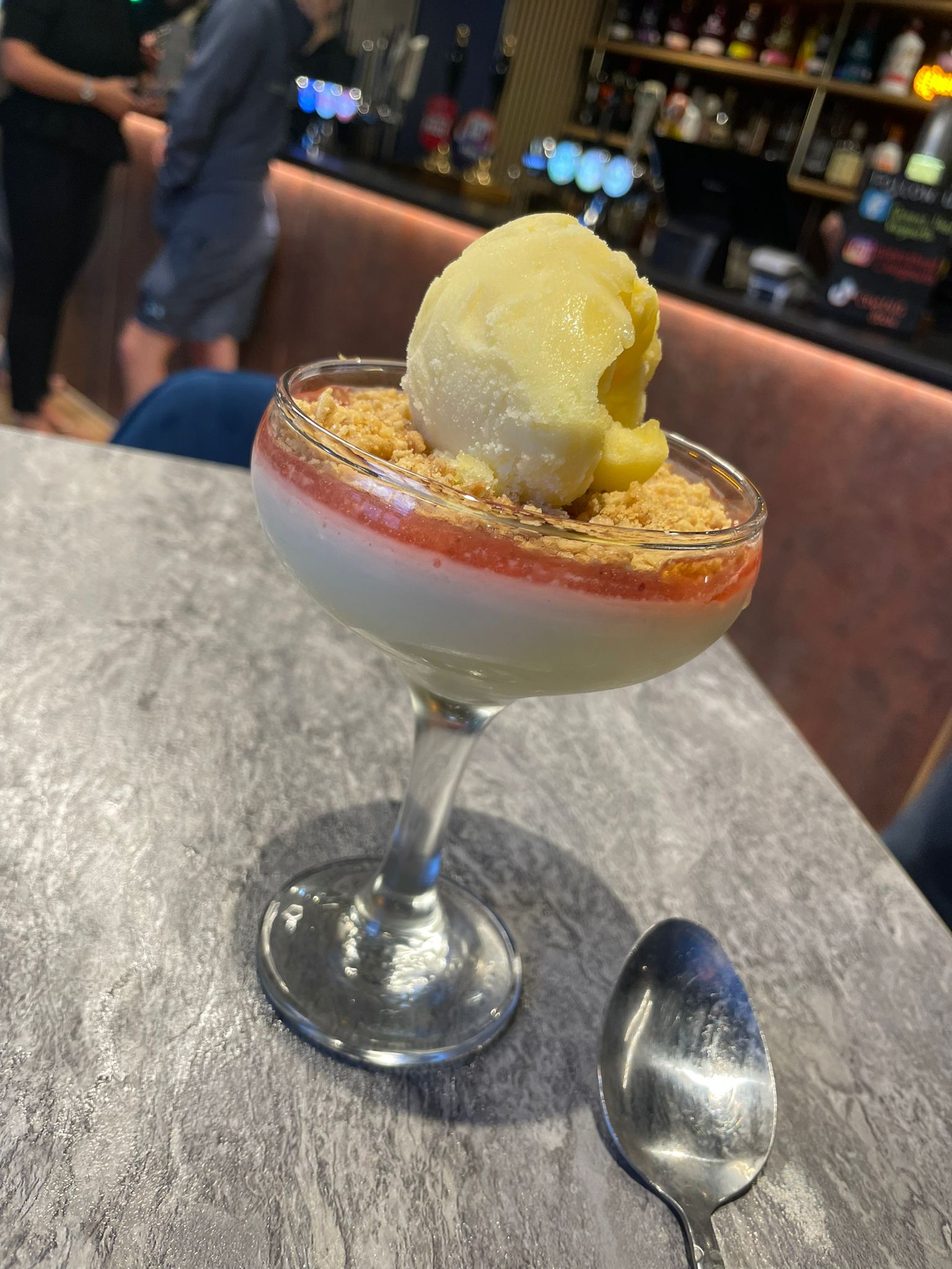 Crumble dessert with icecream served at The Queen's Head Kingsnorth pub